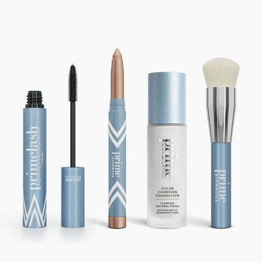 Four Prime Prometics™ products from the Restore Your Glow Set stand upright in glossy light blue packaging on a white background.